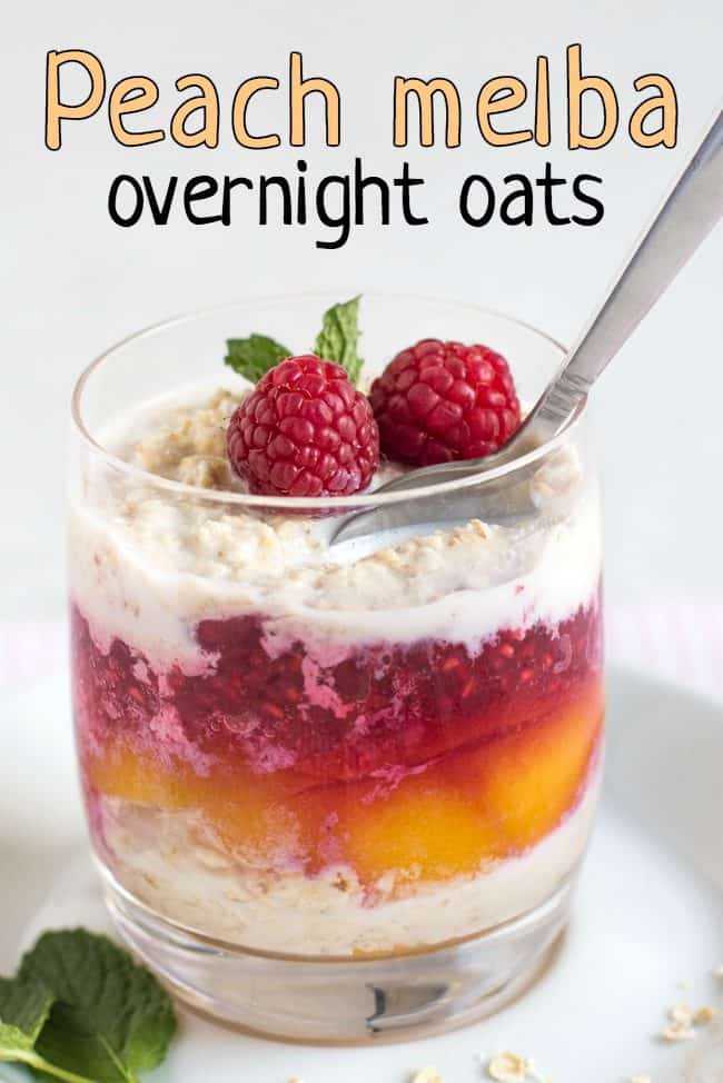 Layered overnight oats with peaches and raspberry sauce, topped with fresh raspberries
