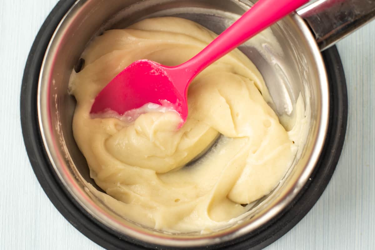 A thick white sauce in a saucepan.
