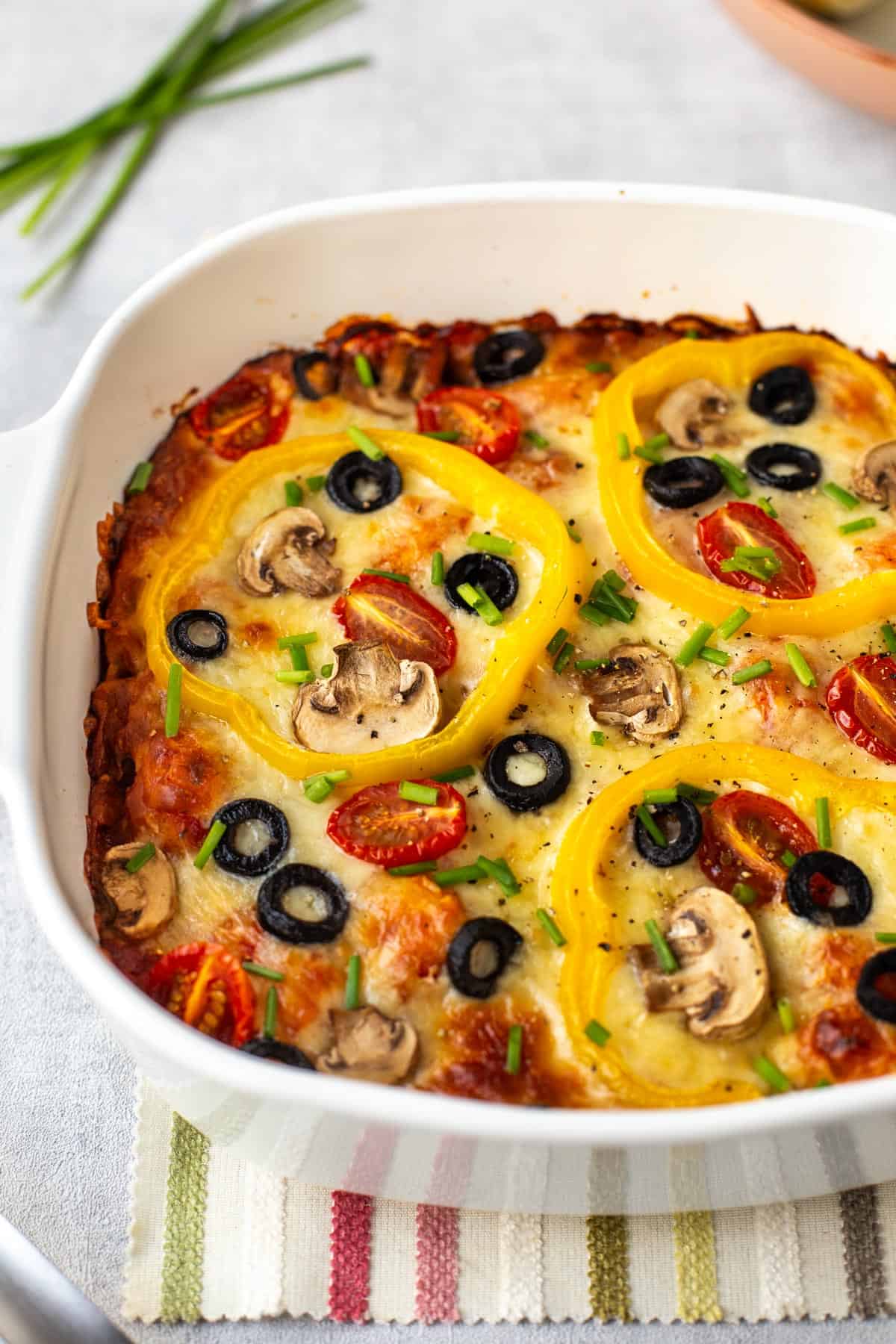Pizza baked gnocchi in a dish topped with pizza toppings.
