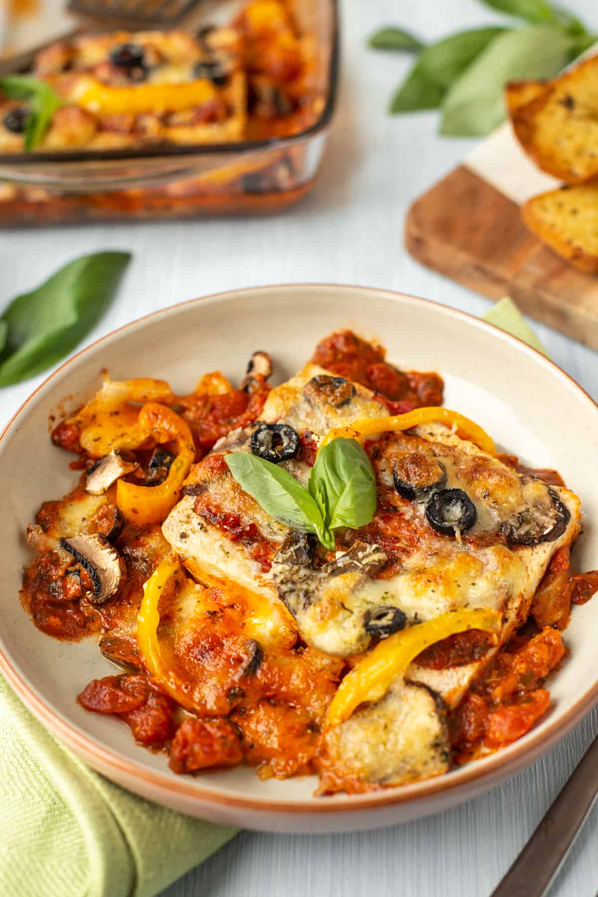 Pizza baked tofu in a bowl with vegetables and cheese.