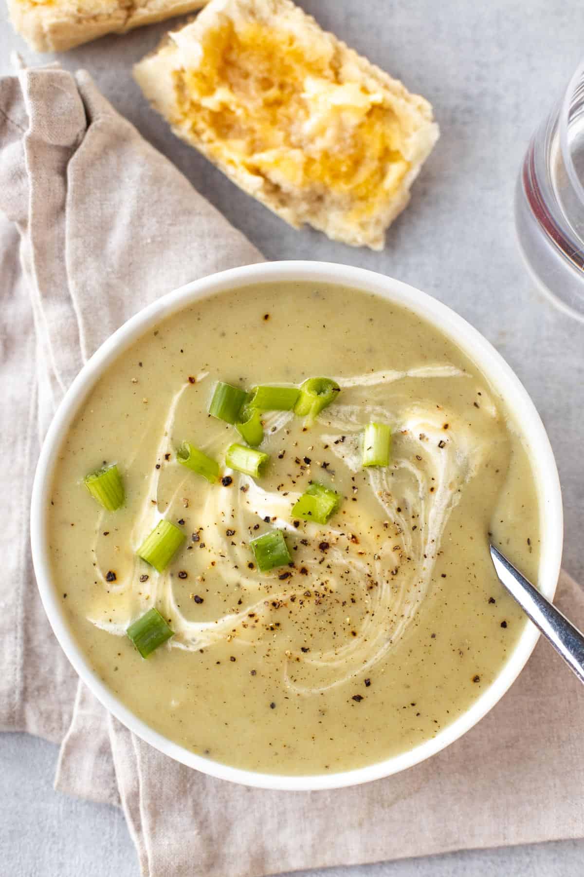 Creamy potato and spring onion soup in a bowl topped with chopped scallions.
