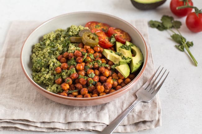 Quinoa and roasted chickpea vegan burrito bowls with avocado and roasted tomatoes