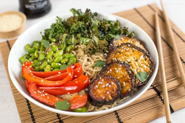 Roasted edamame noodle bowls with miso roasted aubergine and crispy kale