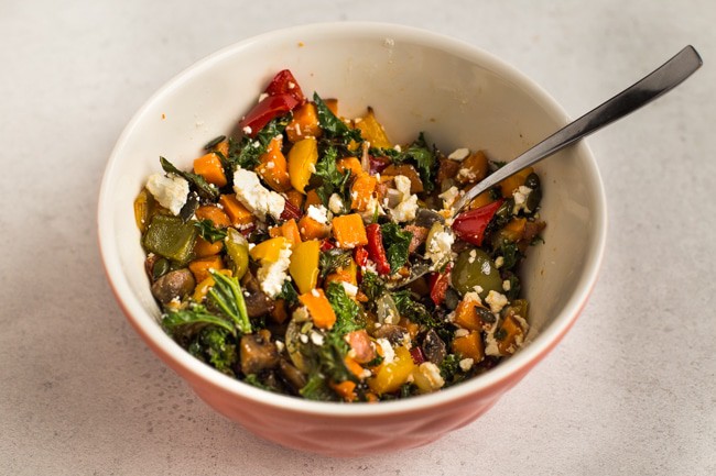 Roasted vegetables with feta cheese in a mixing bowl