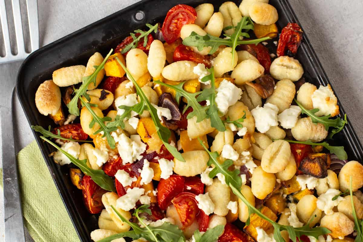 Sheet pan gnocchi cooked with pumpkin and tomatoes.