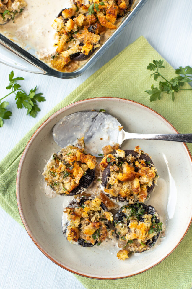 Stuffed mushrooms in a bowl with cream sauce.