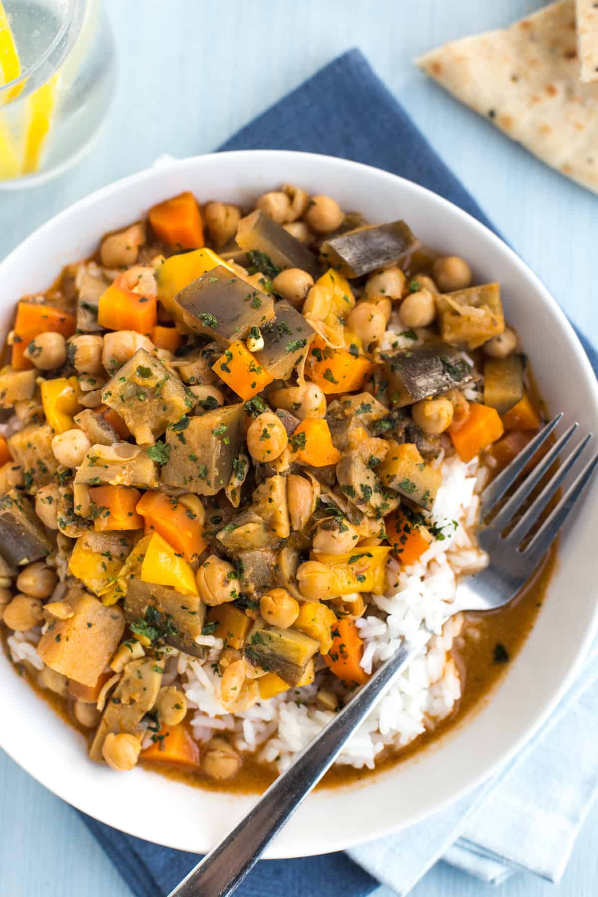 A portion of vegetable and chickpea curry with white rice, shot from above.