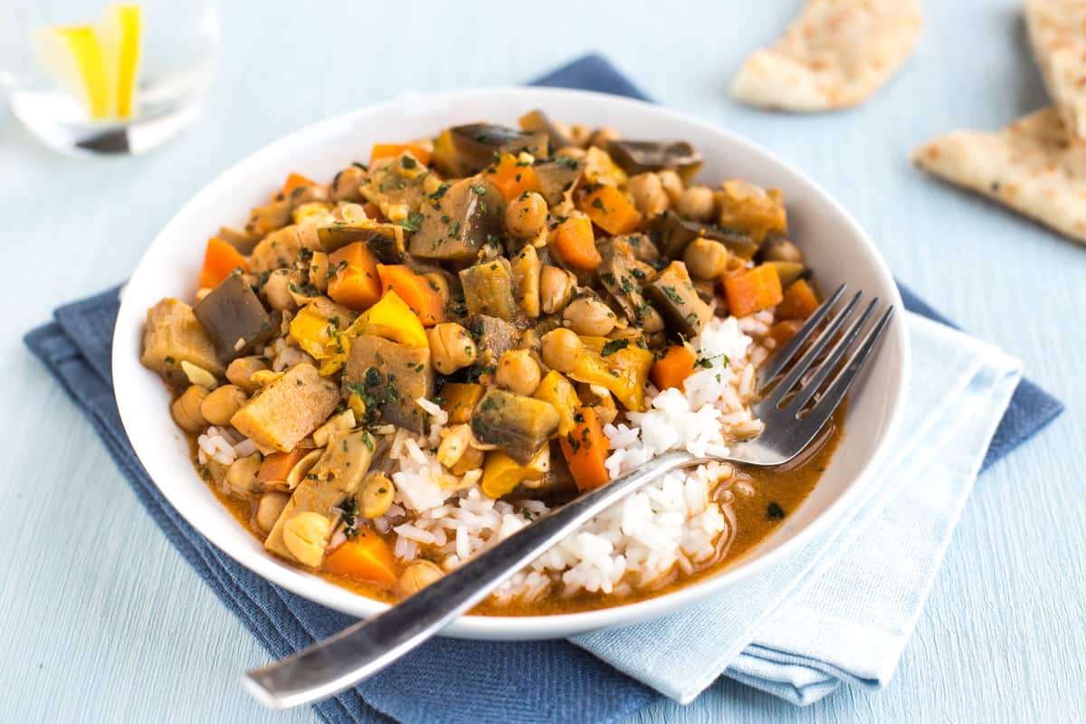 A portion of chickpea curry with rice in a bowl.