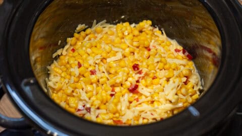 Uncooked ingredients for slow cooker corn casserole in a pot.