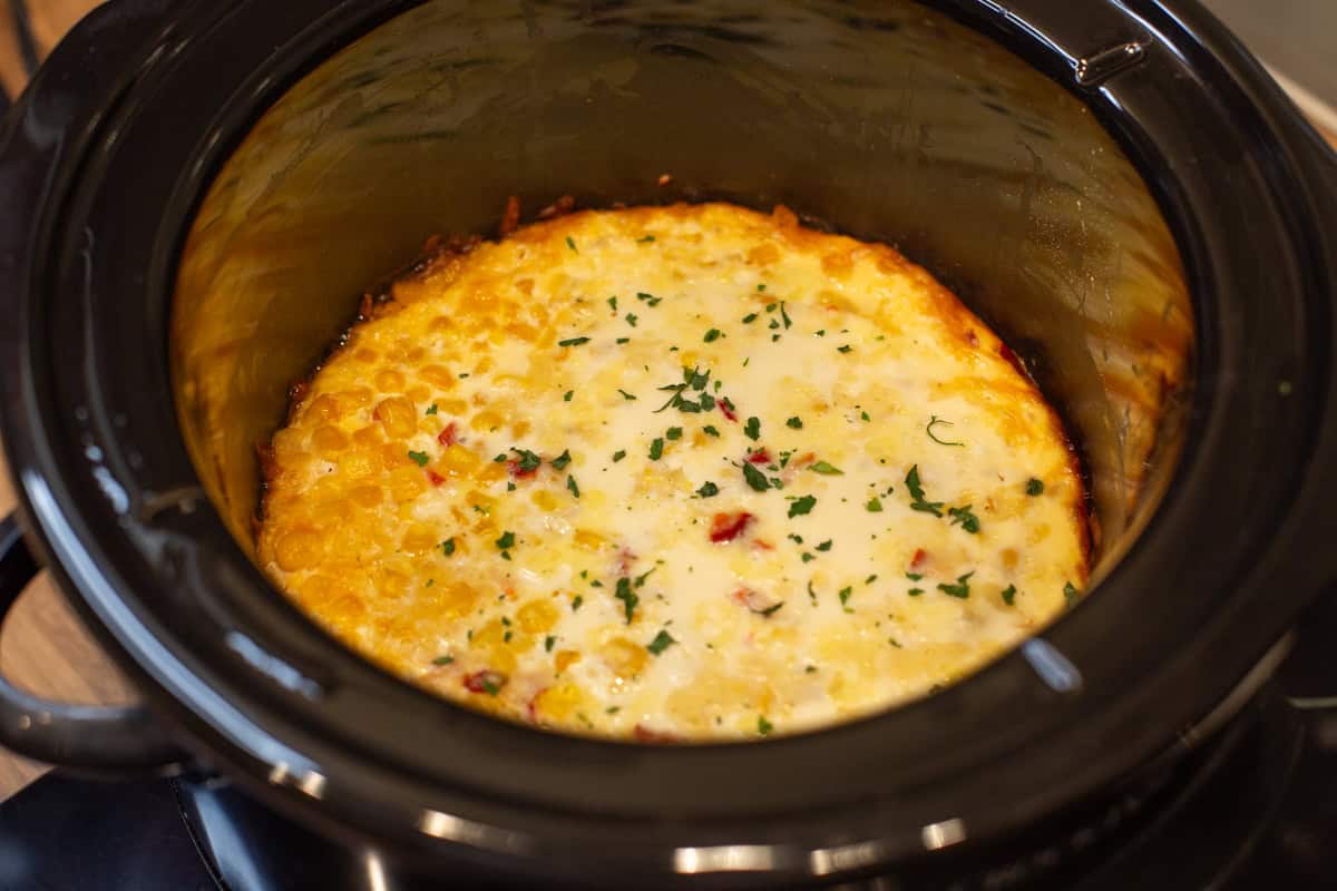 Fully cooked slow cooker corn casserole in a Crock-Pot.