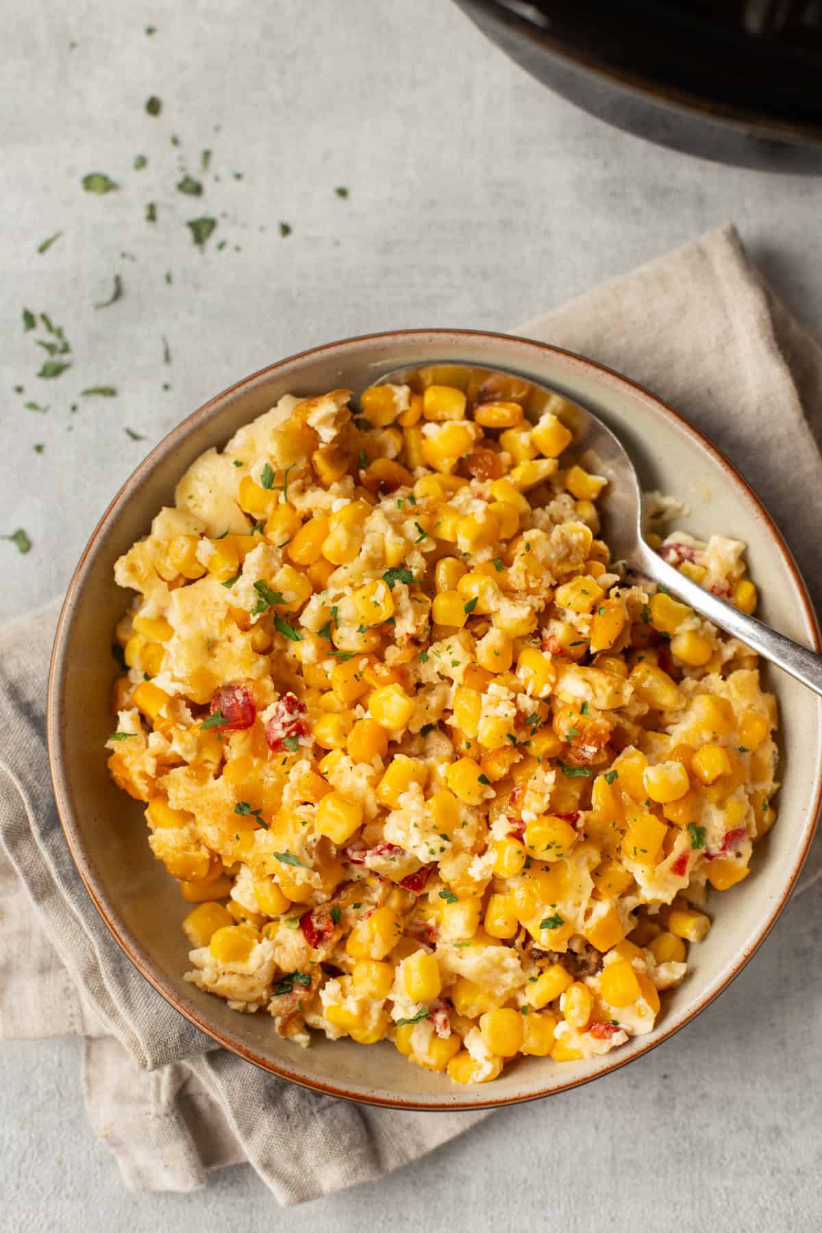 Overhead shot of slow cooker corn casserole in a bowl.
