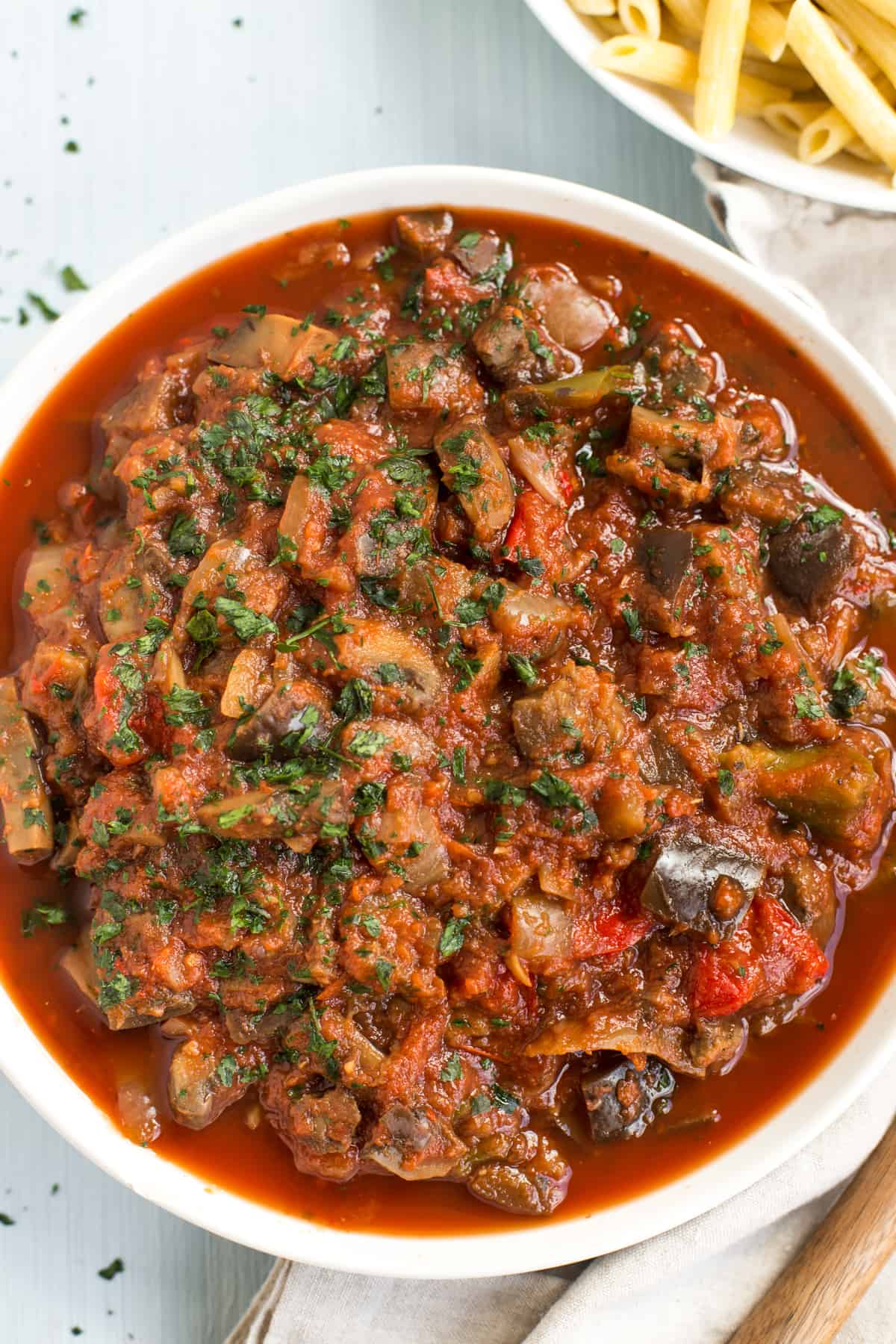 Rich vegetable stew in a white bowl.