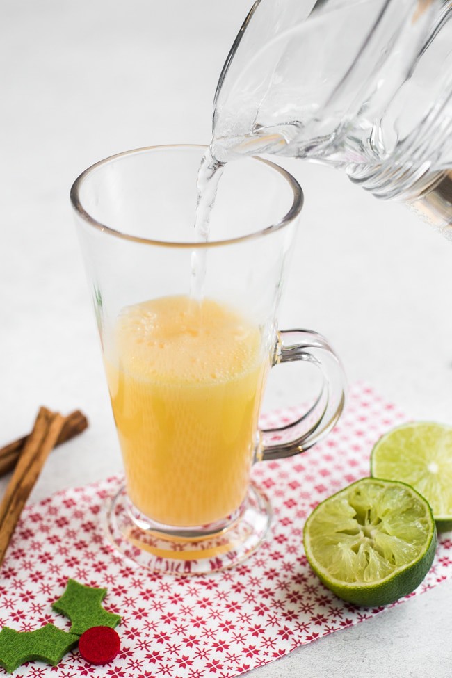 A snowball cocktail being topped up with lemonade.