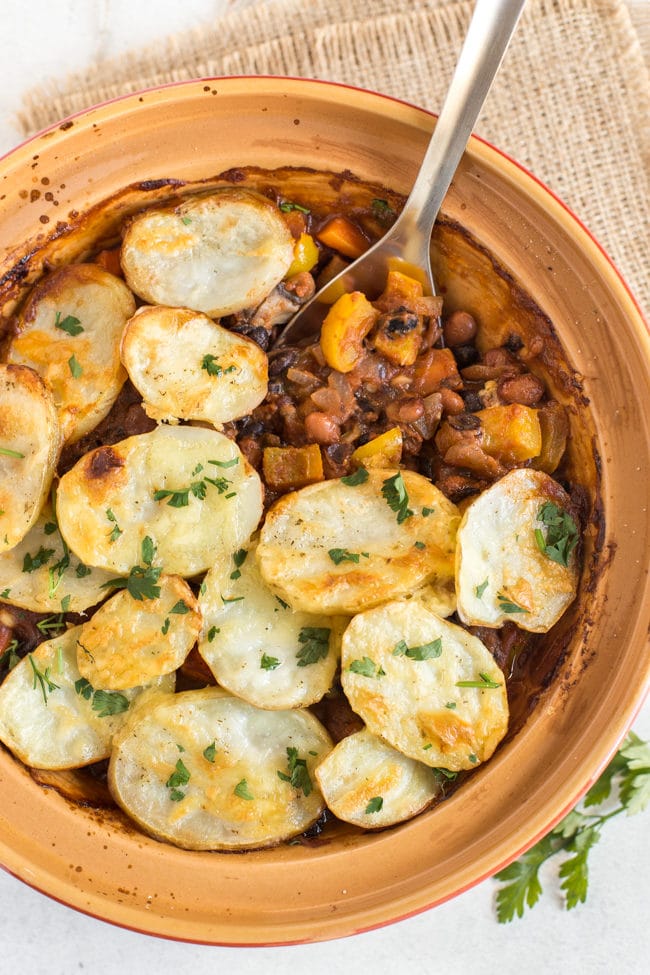 Vegetarian bean hotpot topped with slices of crispy potato.