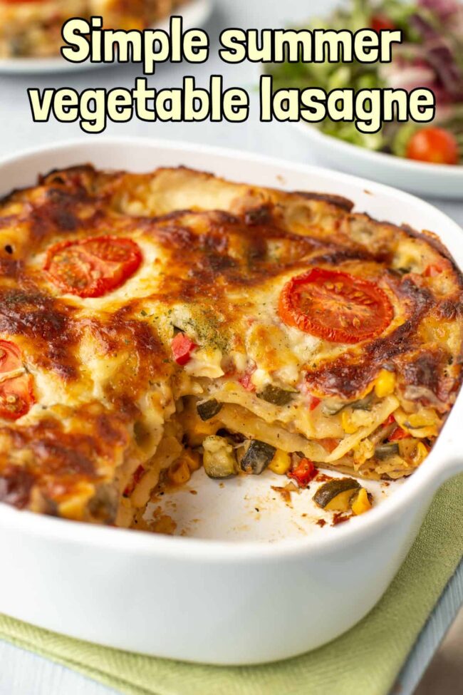 A creamy vegetable lasagne in a dish, with a slice removed.