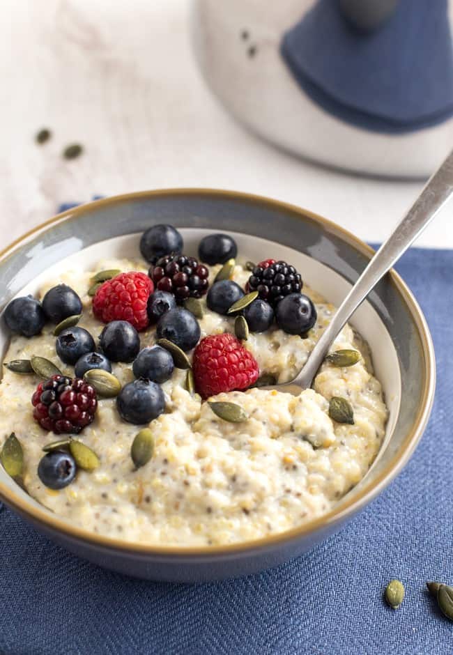 Superfood porridge with quinoa, flax and chia, as well as the usual oats. Topped with pumpkin seeds and berries for even more goodness! A super healthy vegetarian / vegan / gluten-free breakfast.