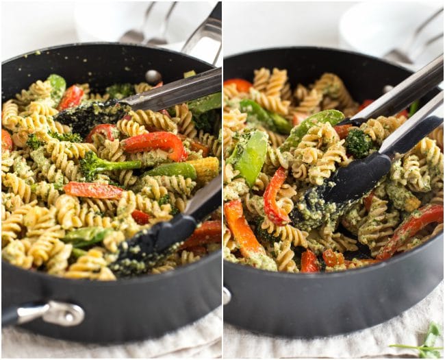 Thai pesto pasta in a pan, being tossed with a pair of tongs