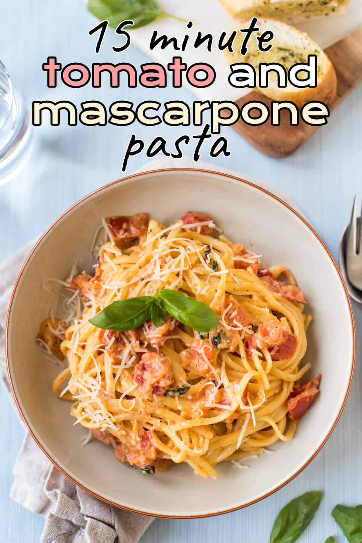 A portion of linguine in tomato and mascarpone sauce in a bowl topped with fresh basil.