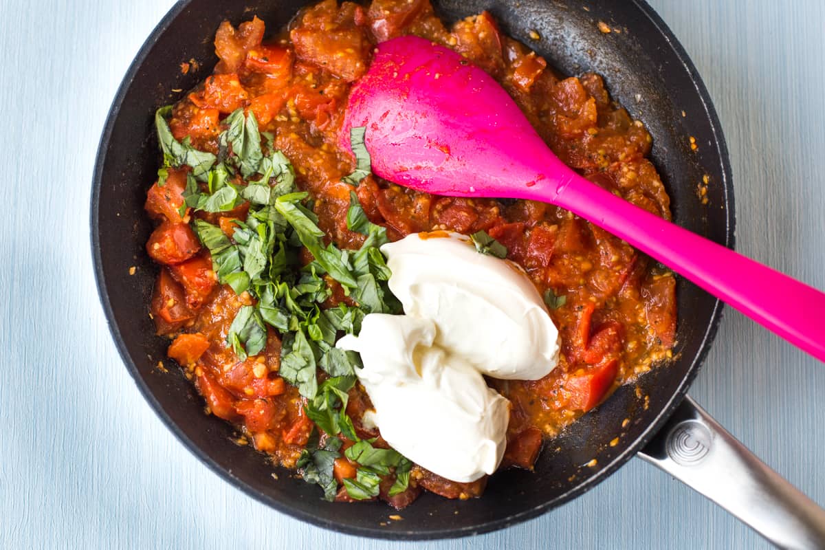 Fresh tomato sauce topped with basil and two dollops of mascarpone cheese.