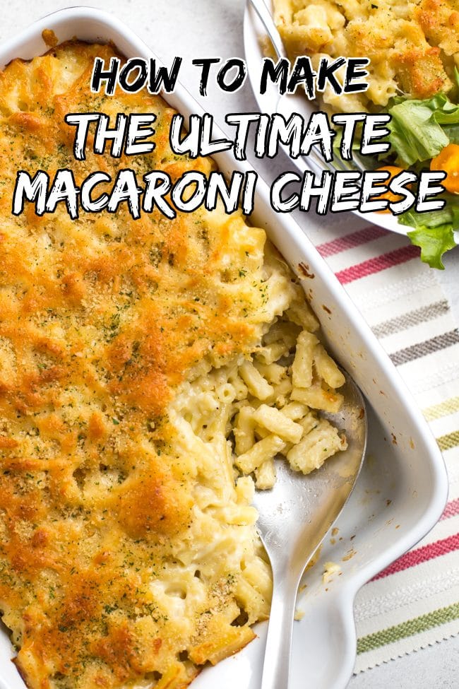 Large dish of macaroni cheese with a crispy topping, with a portion removed with a spoon