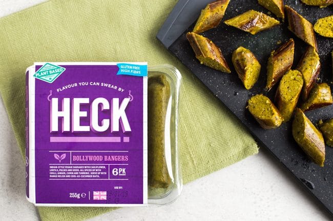 Heck Bollywood Bangers vegan sausages chopped on a cutting board
