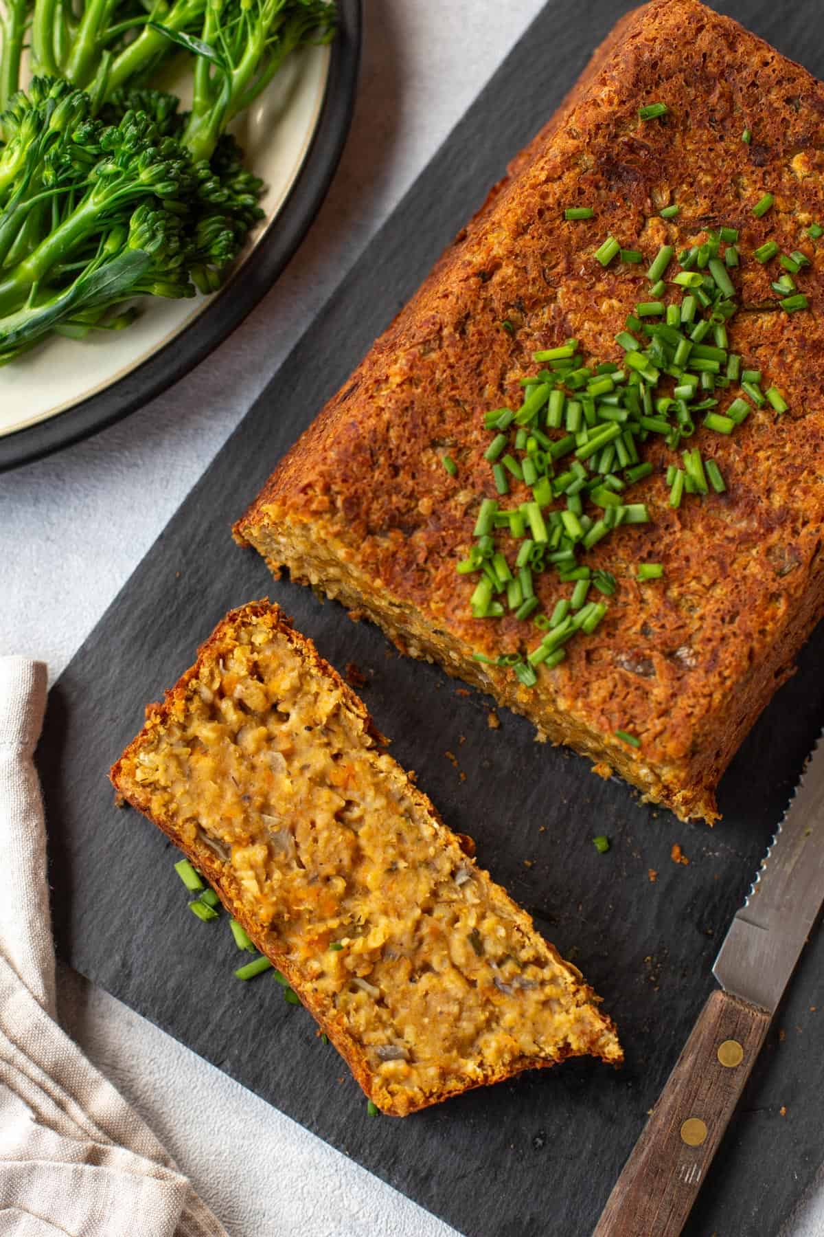 Aerial shot of a vegan lentil loaf with a slice cut off.