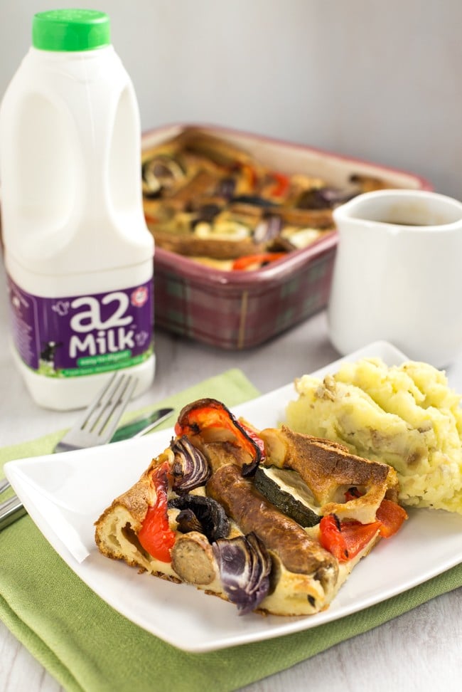 Vegetable toad in the hole - vegetarian sausages and roasted veggies, all cooked in a Yorkshire pudding batter. A classic British recipe!