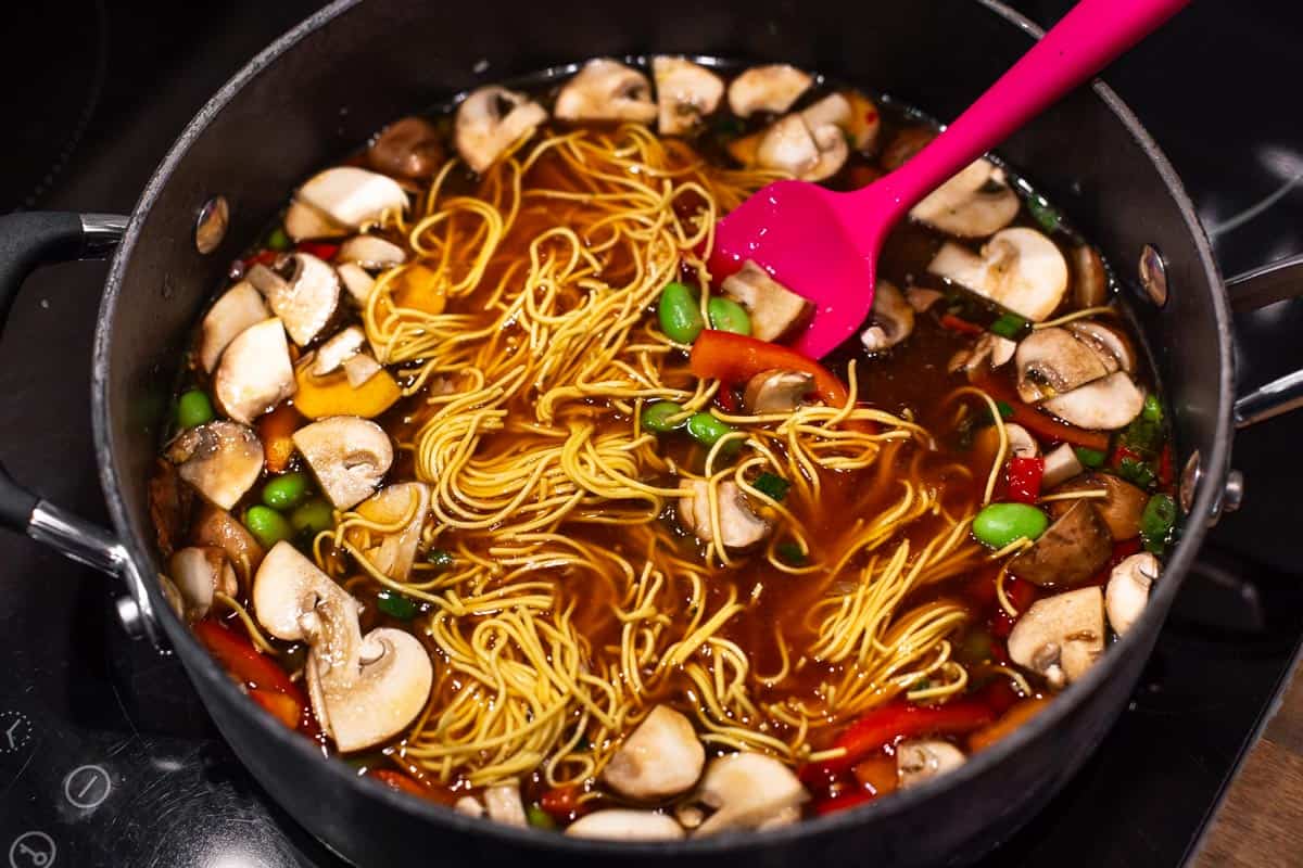 Vegetables and noodles cooking in a tasty broth.