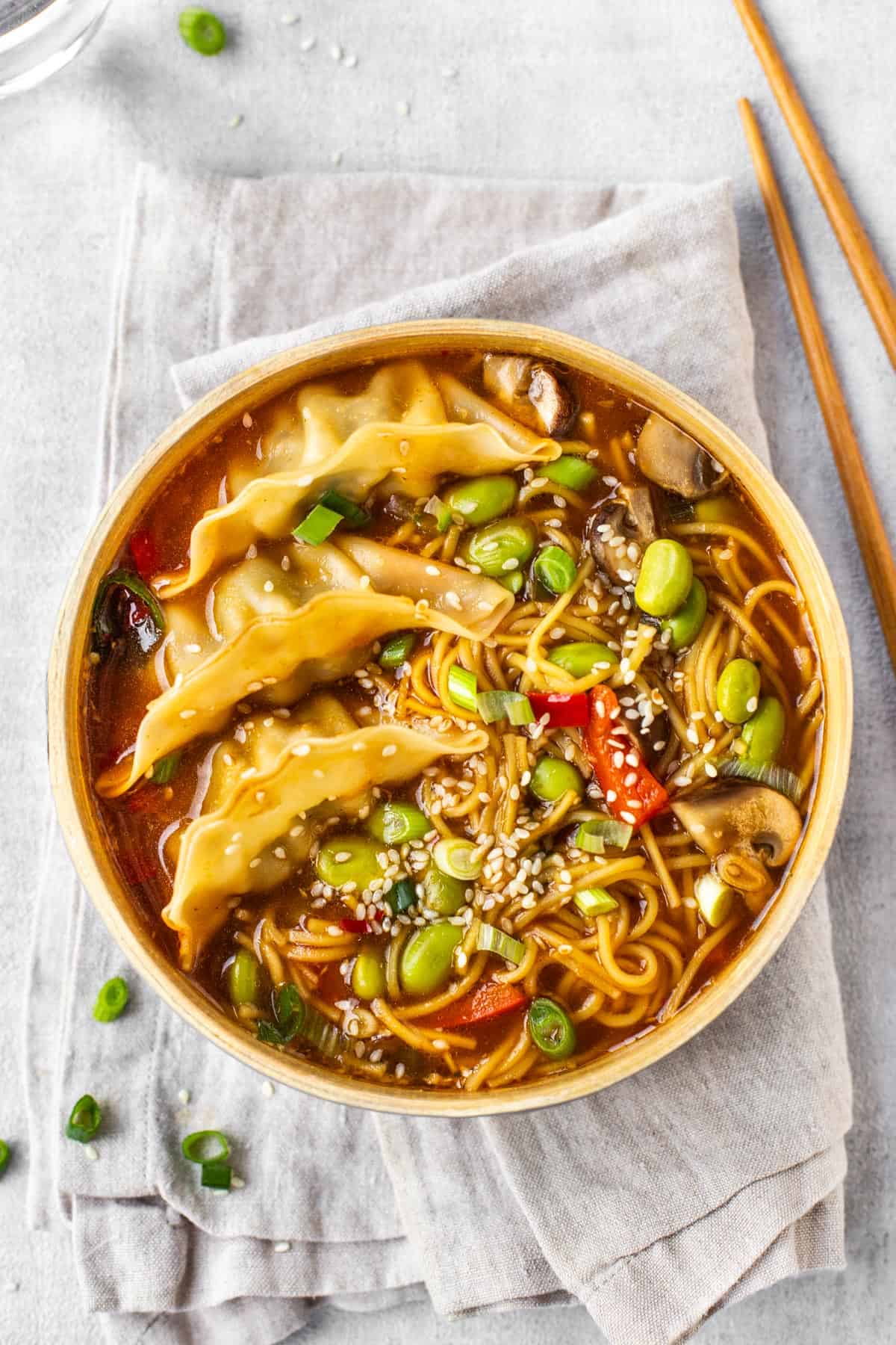 A portion of gyoza soup with noodles and vegetables.