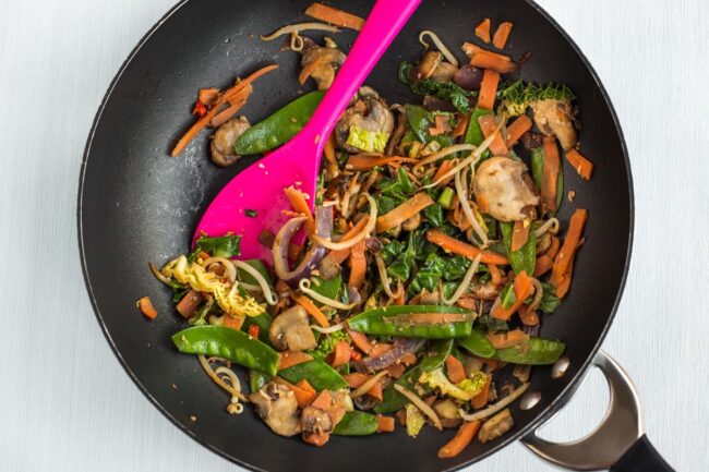 Stir-fried vegetables in a wok.
