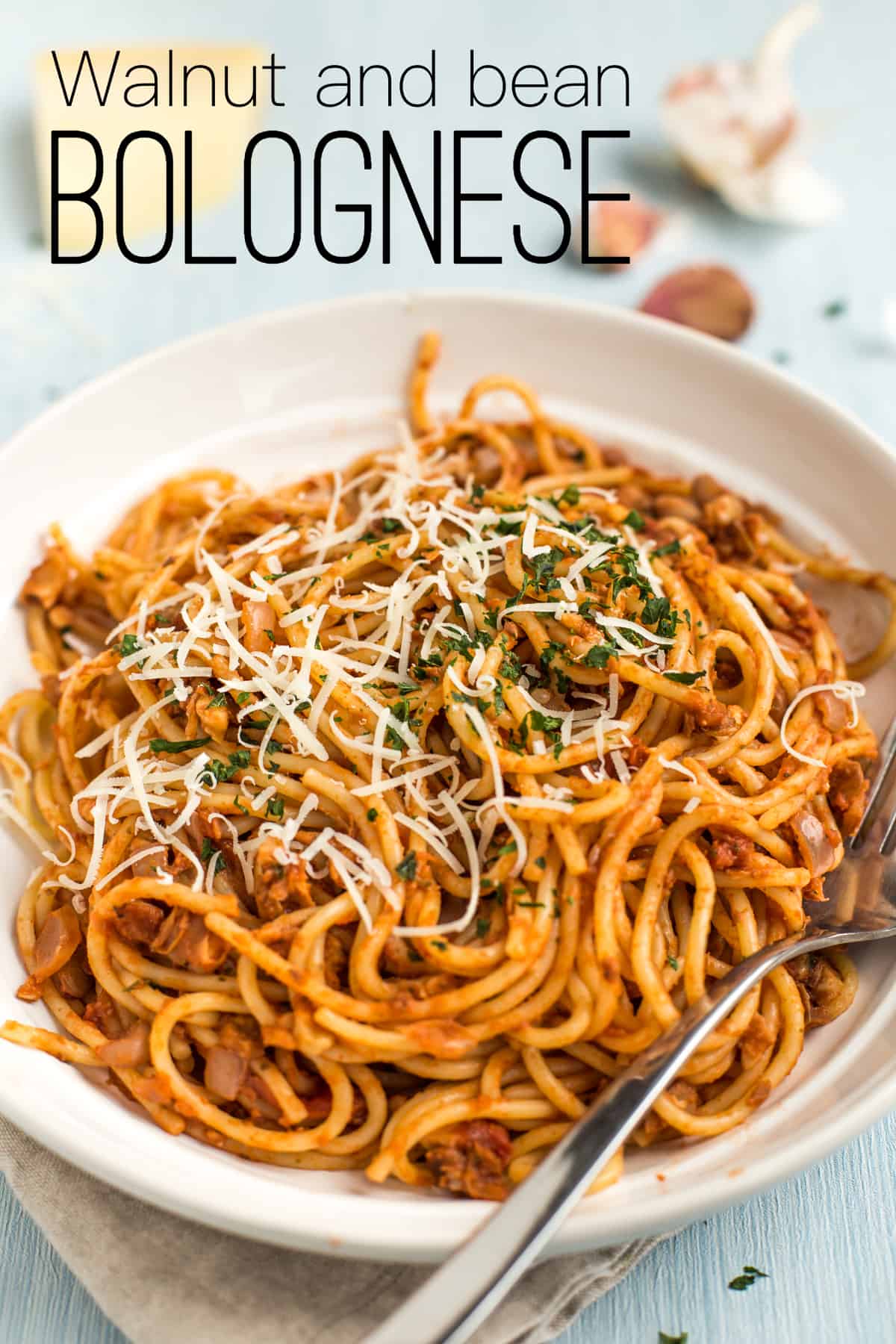 Portion of vegan bean bolognese mixed through spaghetti.